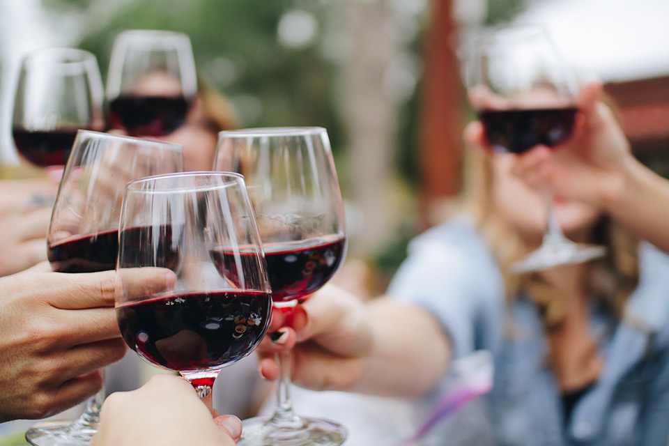 people around table with bottle wines